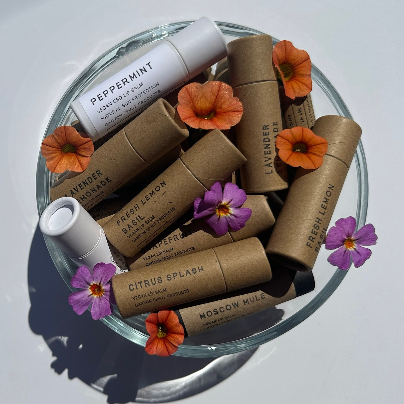 Natural vegan lip balm collection in wicker basket - Canyon Spirit Products handmade skincare